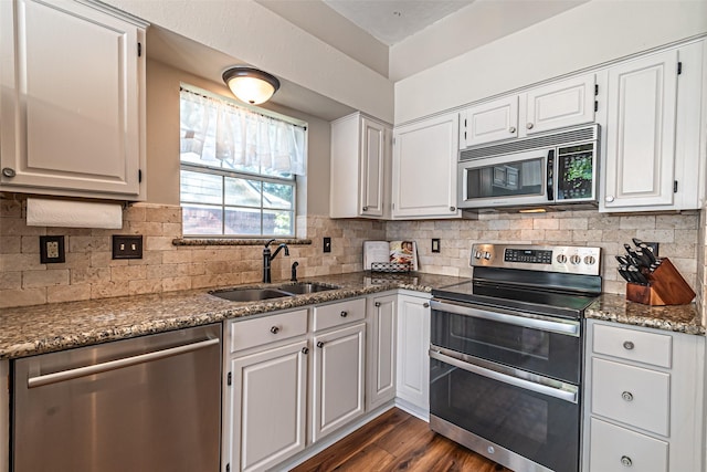 20423 Lone Star Oak St, Cypress, TX 77433 - kitchen with appliances with stainless steel finishes, a sink, dark wood-style flooring, backsplash, and white cabinetry