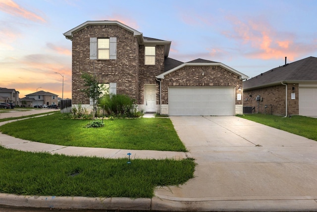 4438 Andorno Dr, Katy, TX 77449 - traditional-style home with brick siding, a garage, driveway, a lawn, and central air condition unit