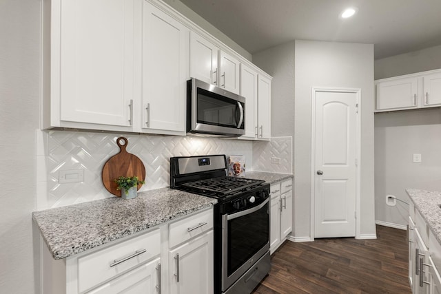 4438 Andorno Dr, Katy, TX 77449 - kitchen featuring appliances with stainless steel finishes, dark wood-style floors, tasteful backsplash, white cabinetry, and recessed lighting