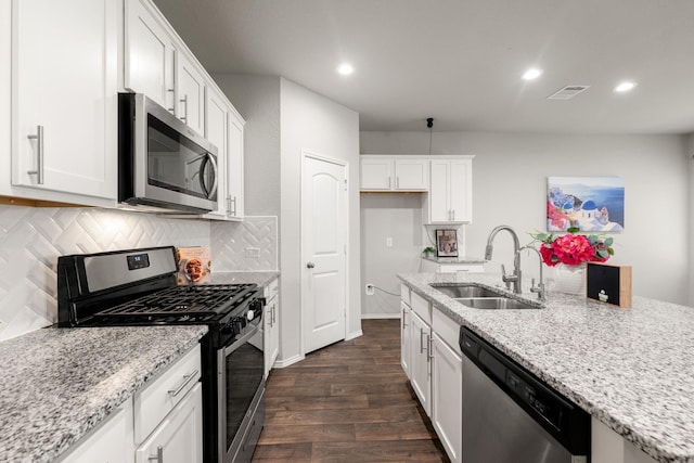 4438 Andorno Dr, Katy, TX 77449 - kitchen with stainless steel appliances, a sink, dark wood-type flooring, white cabinetry, and backsplash