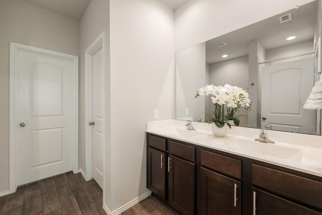 4438 Andorno Dr, Katy, TX 77449 - full bath featuring wood finished floors, double vanity, and baseboards