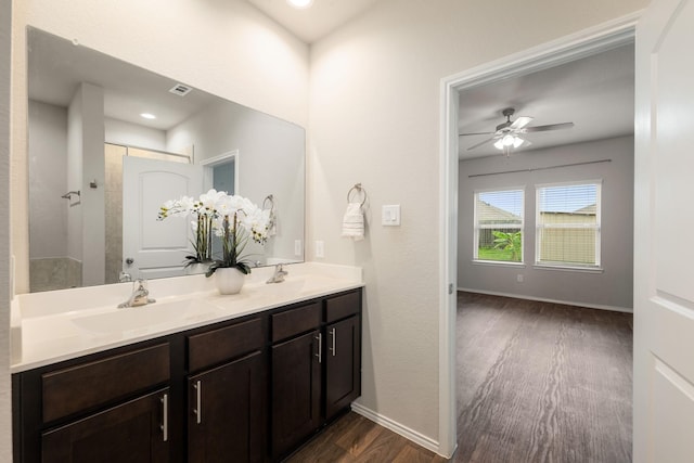 4438 Andorno Dr, Katy, TX 77449 - bathroom featuring wood finished floors, ceiling fan, double vanity, baseboards, and recessed lighting