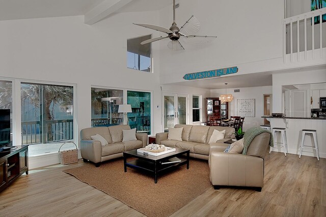 4242 Pelican Ln, Galveston, TX 77554 - living room featuring high vaulted ceiling, light wood finished floors, a ceiling fan, plenty of natural light, and beam ceiling