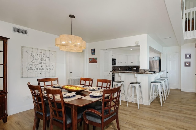 4242 Pelican Ln, Galveston, TX 77554 - dining space featuring light wood-style floors and baseboards