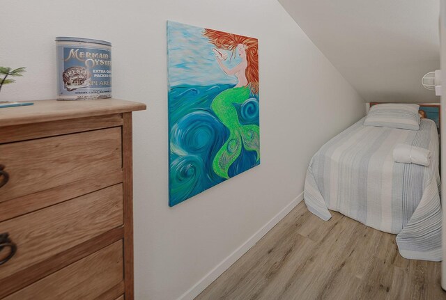4242 Pelican Ln, Galveston, TX 77554 - bedroom with light wood finished floors and baseboards