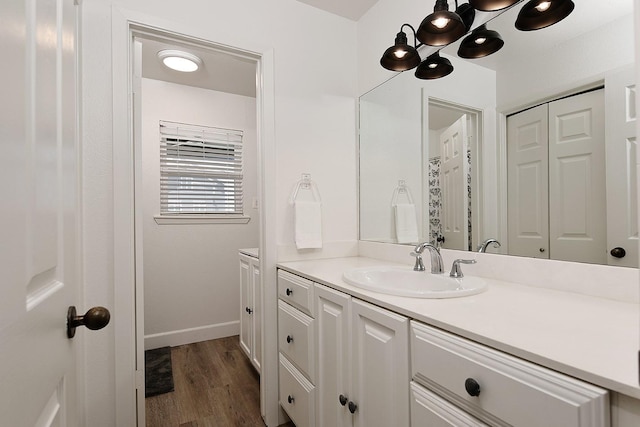 4242 Pelican Ln, Galveston, TX 77554 - bathroom featuring wood finished floors, vanity, and baseboards