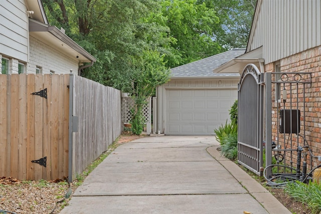 7906 Meadow Lake Ln, Houston, TX 77063 - view of side of property featuring driveway, a gate, a garage, roof with shingles, and fence