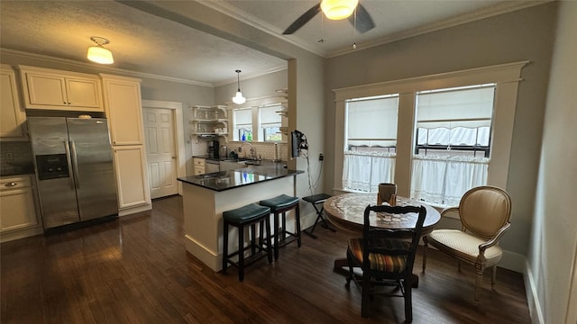 kitchen featuring stainless steel fridge with ice dispenser, ceiling fan, dark countertops, tasteful backsplash, and dark wood-type flooring
