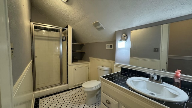 full bathroom featuring lofted ceiling, a textured ceiling, a shower stall, a wainscoted wall, and toilet