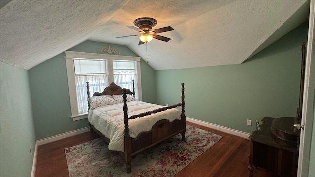 bedroom with a textured ceiling, lofted ceiling, wood finished floors, a ceiling fan, and baseboards