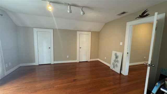 bonus room featuring lofted ceiling, wood finished floors, and baseboards