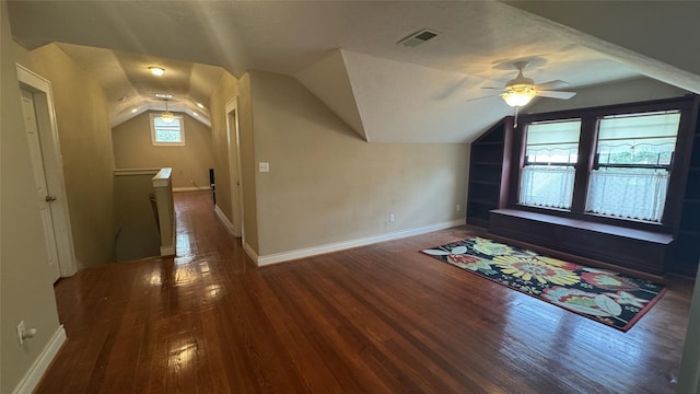 additional living space featuring vaulted ceiling, wood finished floors, ceiling fan, and baseboards