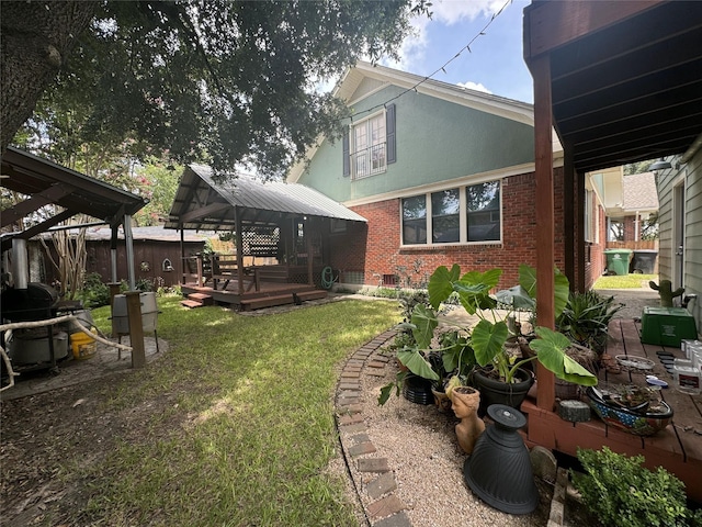 view of grassy yard featuring a gazebo and a deck