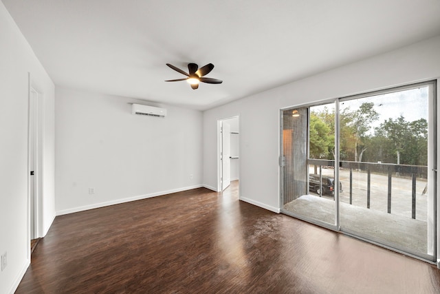 spare room with a wall mounted AC, ceiling fan, wood finished floors, and baseboards