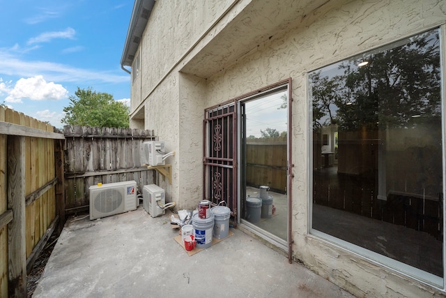 view of patio / terrace with a cooling unit and fence