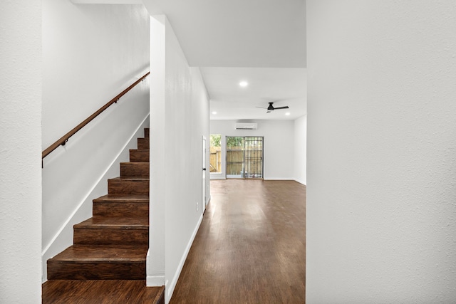 stairway featuring recessed lighting, an AC wall unit, wood finished floors, a ceiling fan, and baseboards