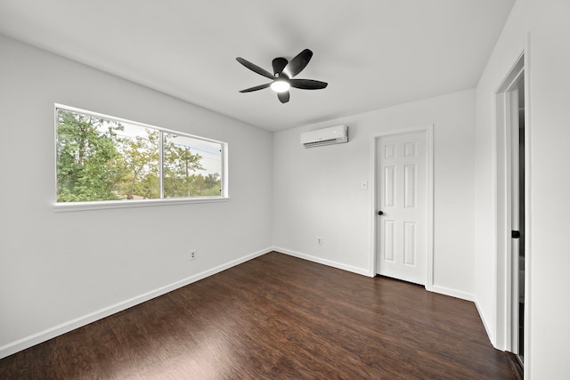 unfurnished bedroom with a wall mounted AC, dark wood-type flooring, baseboards, and ceiling fan