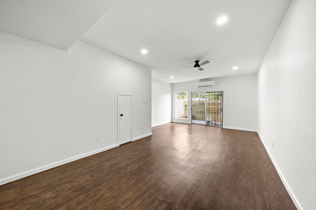 spare room featuring an AC wall unit, recessed lighting, ceiling fan, dark wood finished floors, and baseboards