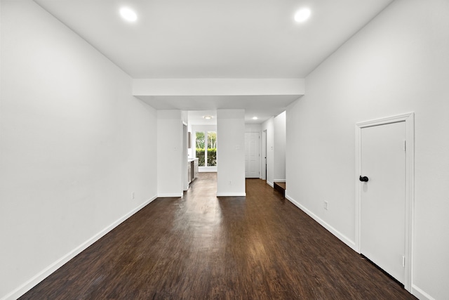 unfurnished room featuring dark wood-style flooring, recessed lighting, and baseboards