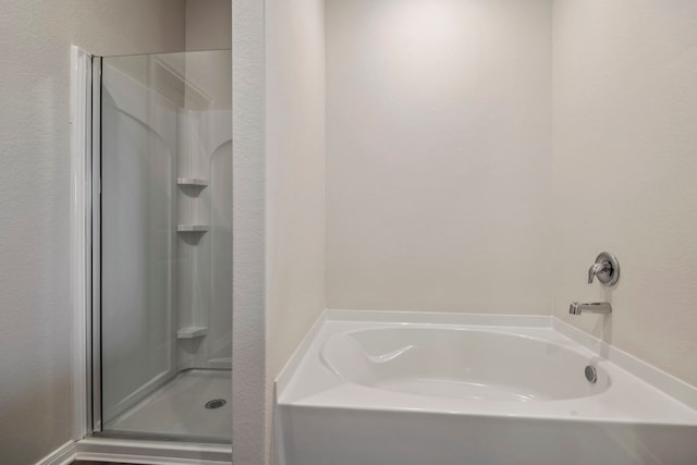 16449 Blossom Grove Dr, Conroe, TX 77303 - full bath with a shower stall, a garden tub, and a textured wall