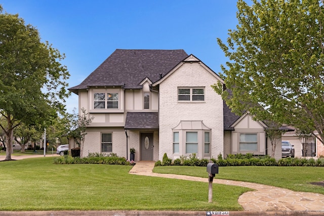 10830 Piping Rock Ln, Houston, TX 77042 - view of front of house with a front yard, brick siding, and roof with shingles