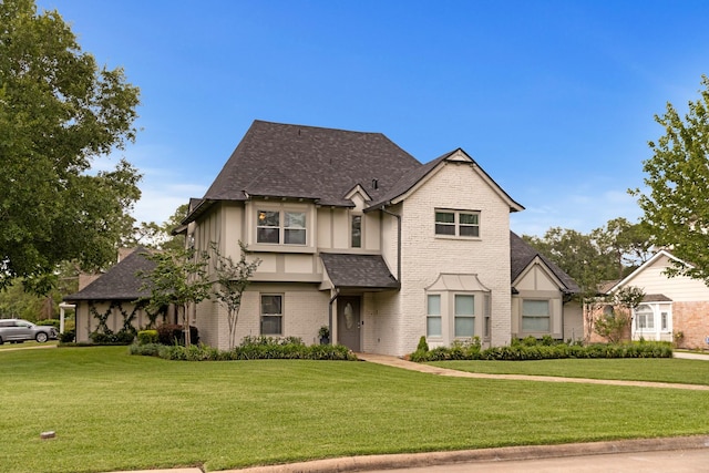 10830 Piping Rock Ln, Houston, TX 77042 - view of front of home featuring a front lawn, a shingled roof, stucco siding, and brick siding