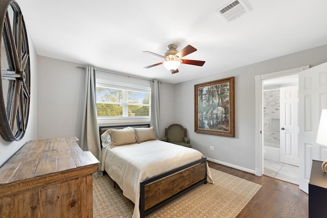 10830 Piping Rock Ln, Houston, TX 77042 - bedroom featuring dark wood-style flooring, baseboards, ensuite bathroom, and a ceiling fan