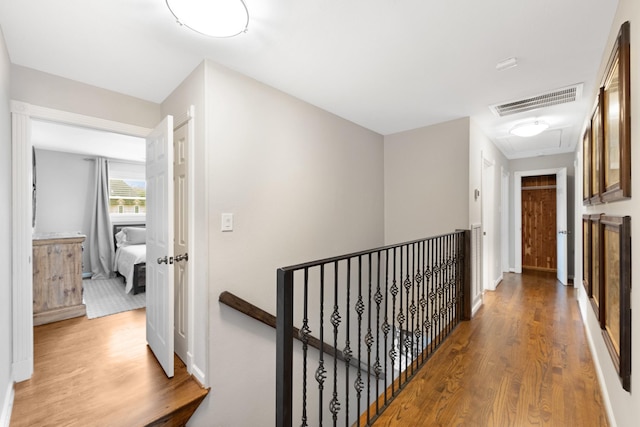 10830 Piping Rock Ln, Houston, TX 77042 - corridor with an upstairs landing, wood finished floors, attic access, and baseboards