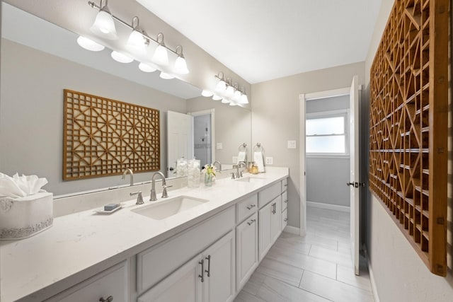 10830 Piping Rock Ln, Houston, TX 77042 - bathroom featuring double vanity, baseboards, and tile patterned flooring