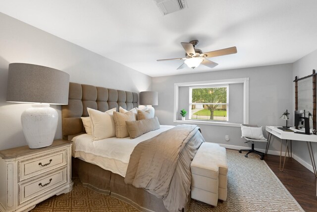 10830 Piping Rock Ln, Houston, TX 77042 - bedroom featuring wood finished floors, a ceiling fan, and baseboards