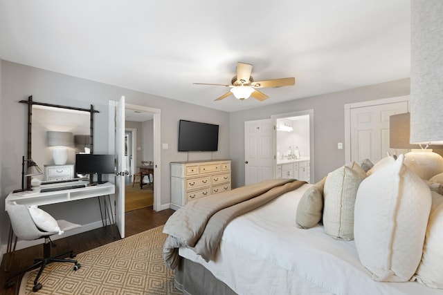 10830 Piping Rock Ln, Houston, TX 77042 - bedroom with wood finished floors, a desk, baseboards, ensuite bathroom, and ceiling fan