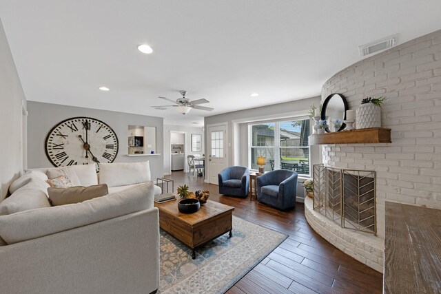 10830 Piping Rock Ln, Houston, TX 77042 - living area with dark wood-style flooring, a ceiling fan, recessed lighting, and a brick fireplace