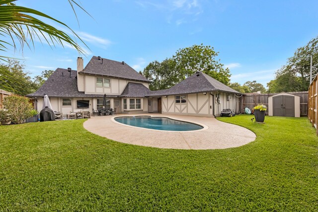 10830 Piping Rock Ln, Houston, TX 77042 - view of swimming pool with a storage shed, a patio, and an outbuilding