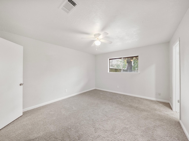 spare room featuring ceiling fan, carpet flooring, and baseboards