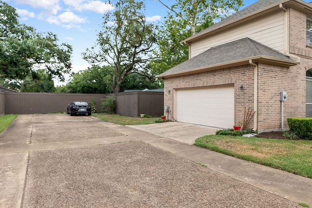 7615 Brae Acres Ct, Houston, TX 77074 - view of property exterior with driveway, brick siding, fence, and roof with shingles