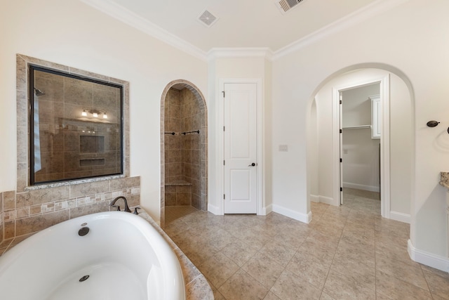 full bathroom featuring a tile shower, a bath, crown molding, and baseboards