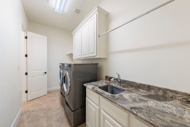 laundry area featuring independent washer and dryer, cabinet space, baseboards, and light tile patterned floors
