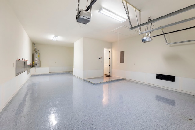 garage featuring gas water heater, a garage door opener, and electric panel