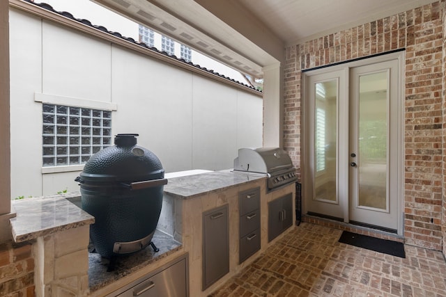 view of patio with area for grilling and a grill