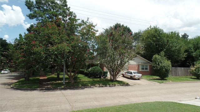 view of front of house featuring fence and brick siding