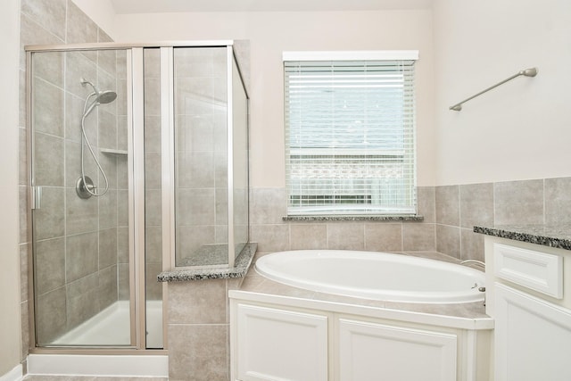 7718 Collina Landing Trl, Richmond, TX 77407 - bathroom with healthy amount of natural light, a shower stall, and a bath