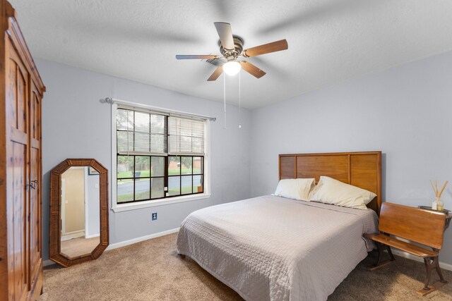 1001 Windy Dr, Brenham, TX 77833 - bedroom featuring light carpet, baseboards, and ceiling fan