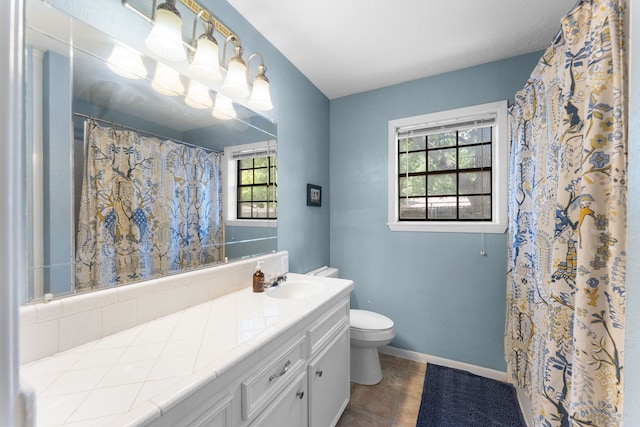 1001 Windy Dr, Brenham, TX 77833 - bathroom featuring toilet, vanity, baseboards, tile patterned floors, and curtained shower
