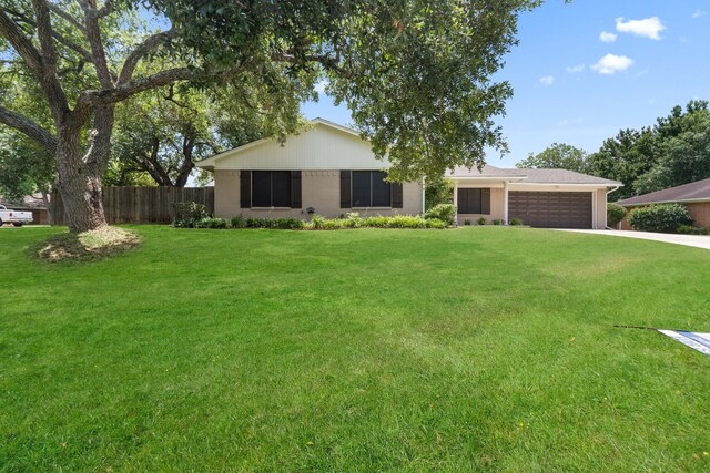 single story home featuring an attached garage and driveway