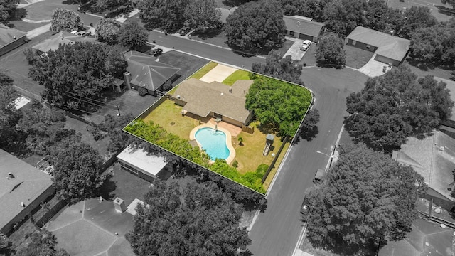 aerial view of property and surrounding area with a pool and property boundaries highlighted