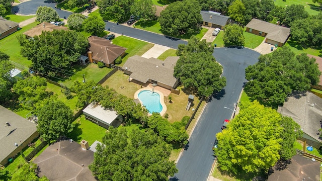aerial overview of property's location featuring a pool area and nearby suburban area