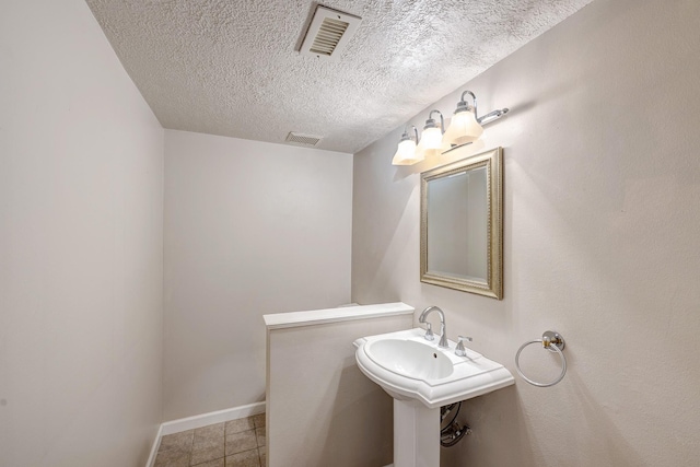 491 N Post Oak Ln Unit 491, Houston, TX 77024 - half bath featuring a textured ceiling, tile patterned floors, and baseboards