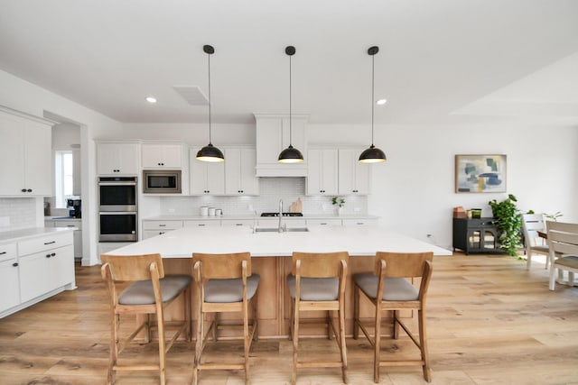 4914 Olive Province Ln, Manvel, TX 77578 - kitchen with stainless steel appliances, tasteful backsplash, light wood finished floors, light countertops, and recessed lighting