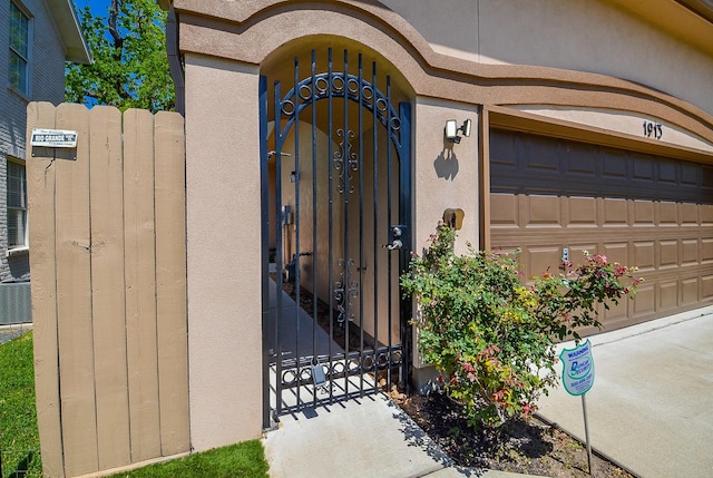 1913 Rosewood St, Houston, TX 77004 - view of exterior entry featuring a gate, stucco siding, and fence