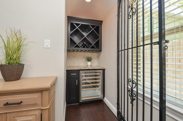 1913 Rosewood St, Houston, TX 77004 - wine area with beverage cooler, dark wood finished floors, a bar, and baseboards